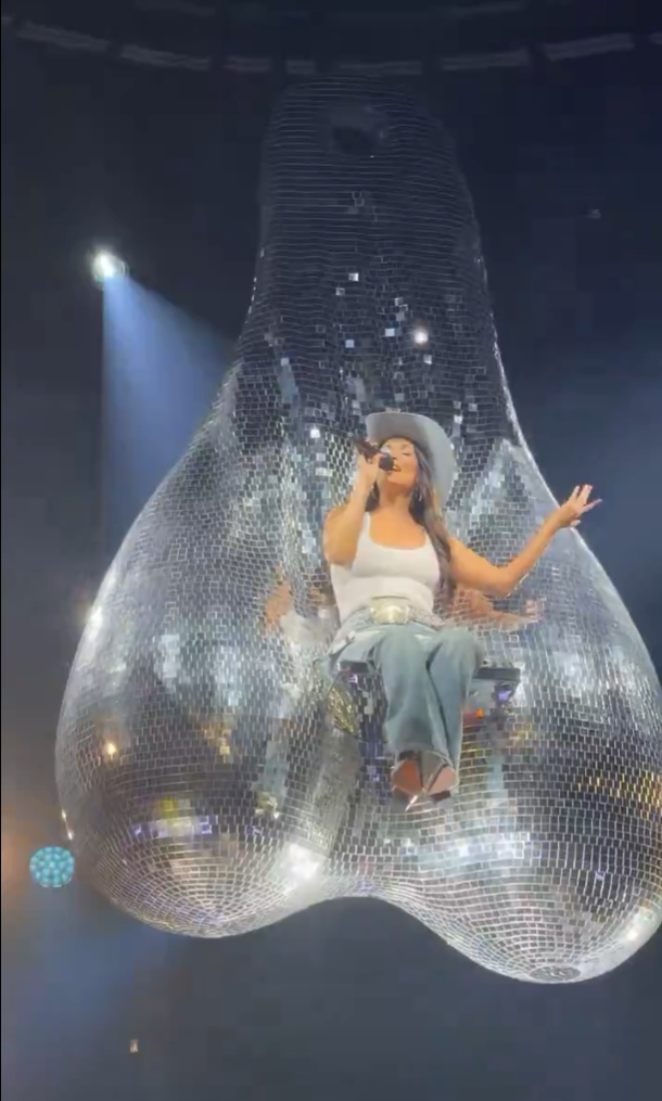 Original concert post showing the singer on the mirrored sculpture